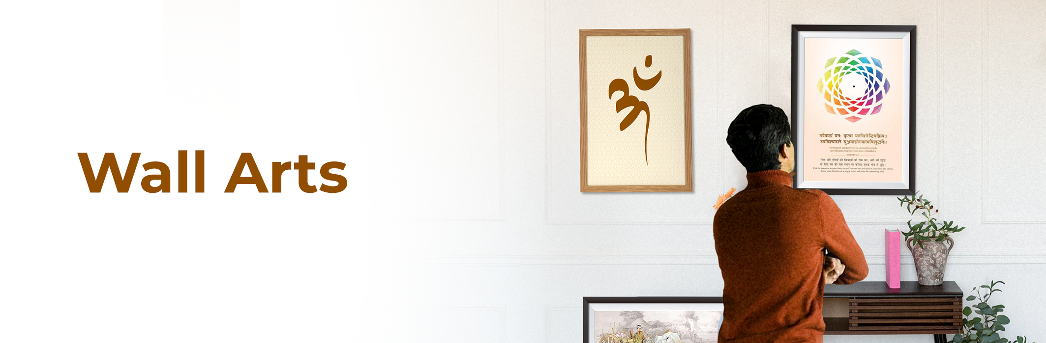 Man viewing MahaVastu wall arts, including Om symbol and colorful Vastu painting, on modern wall