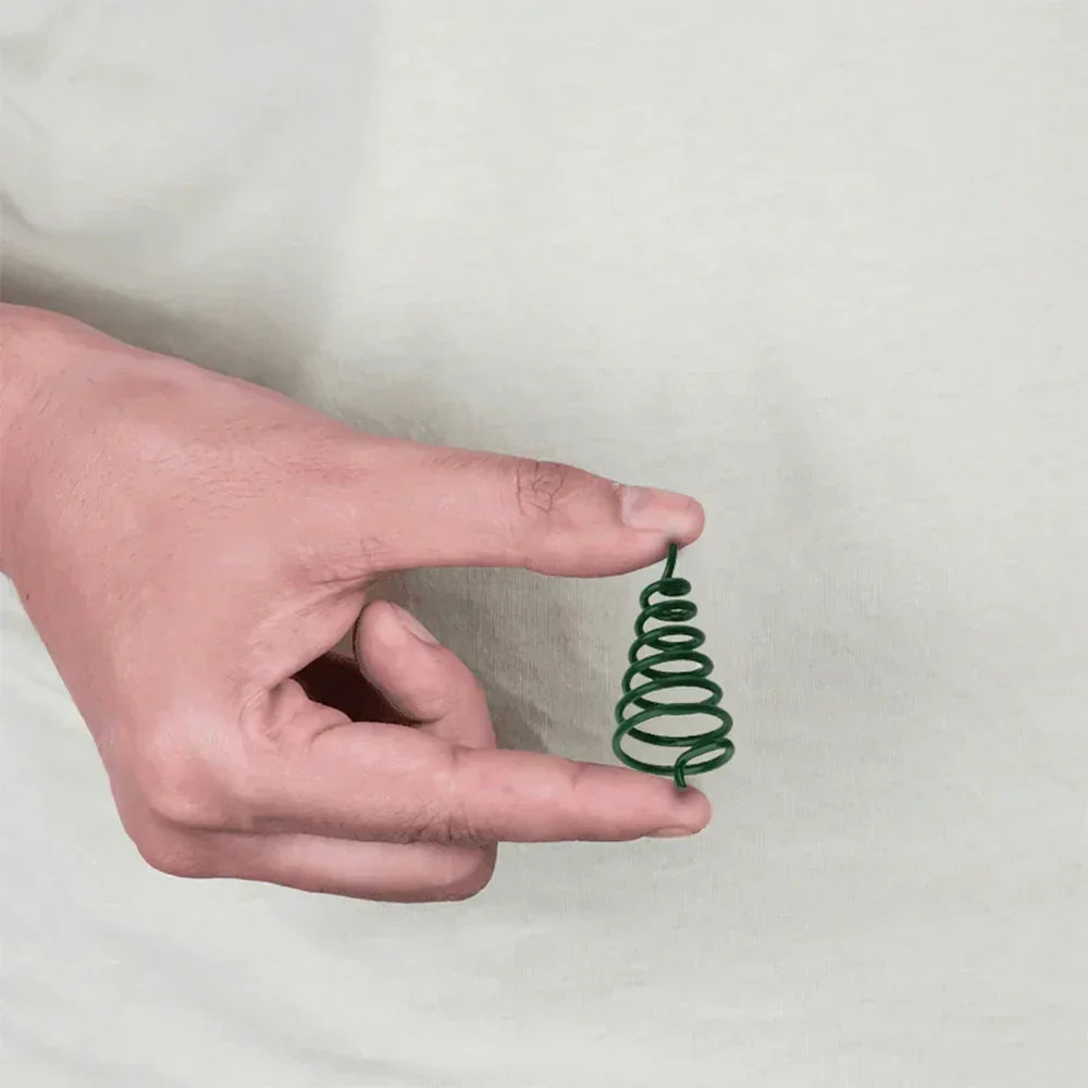 Hand holding green MahaVastu air element spiral remedy for Vastu Shastra balance