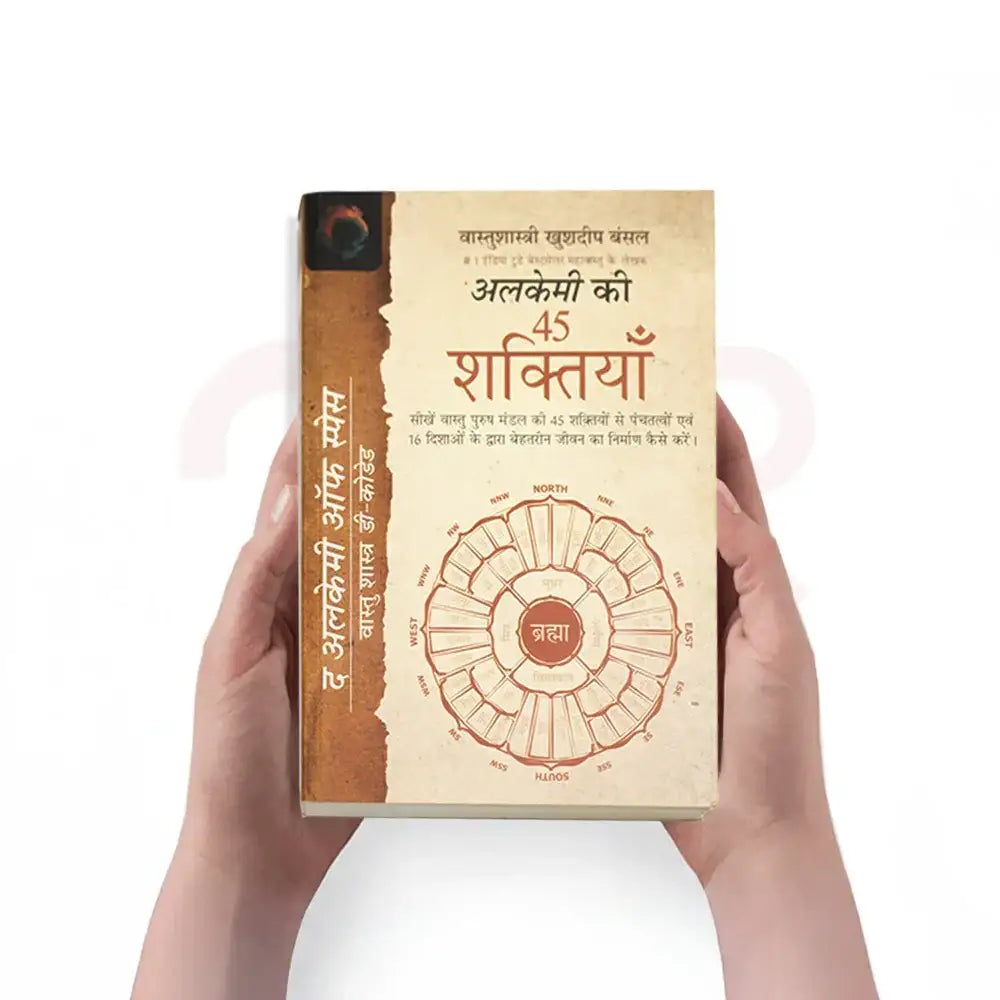 A person holding a Hindi book titled Alkemey Ki 45 Shaktiyan about Maha Vastu Shastra remedies.