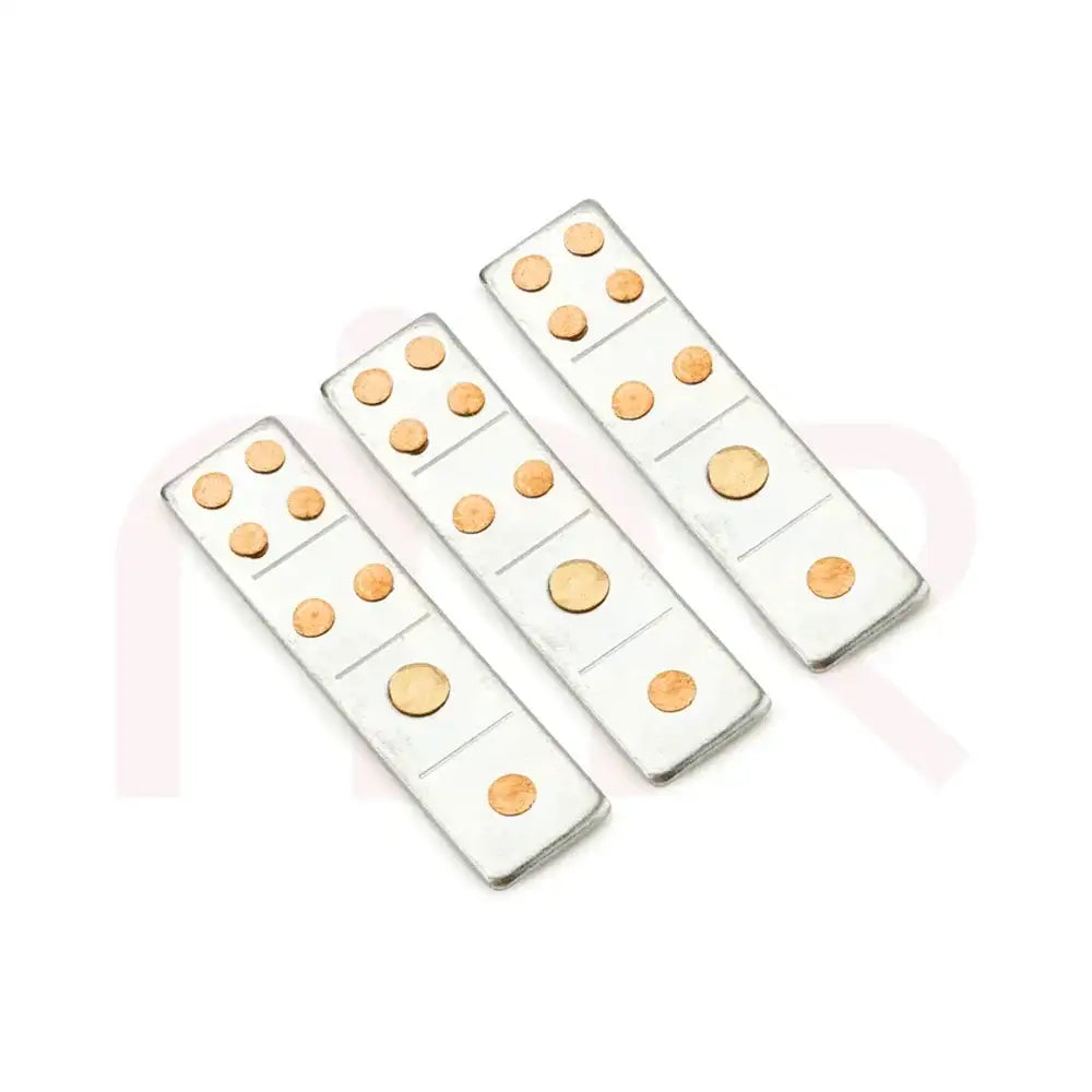Three silver metal strips with copper dots for Maha Vastu remedies.