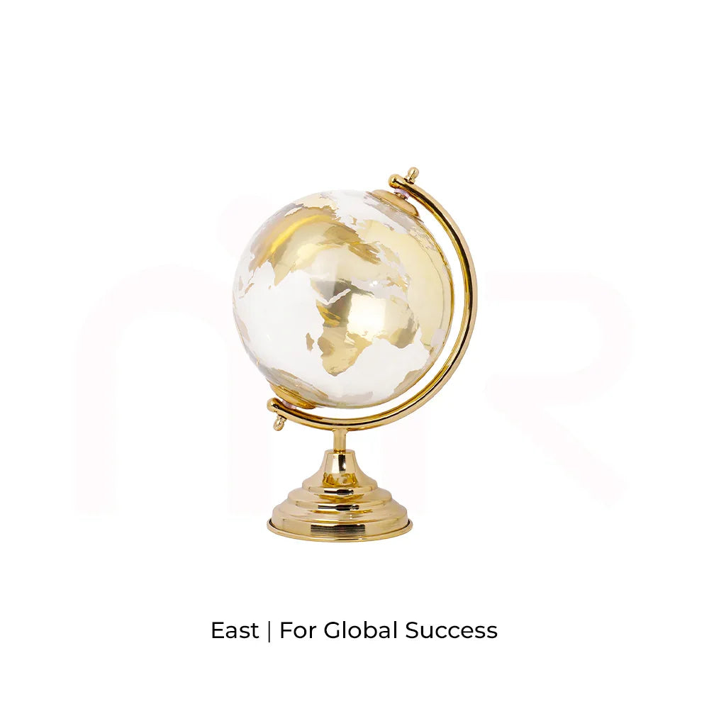 Golden MahaVastu globe remedy for global success, placed on white background