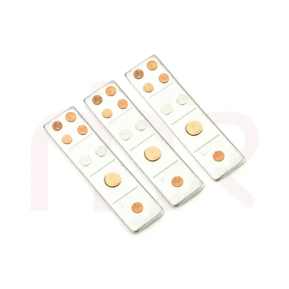 Three silver Vastu metal strips with embedded copper dots for energy balancing.