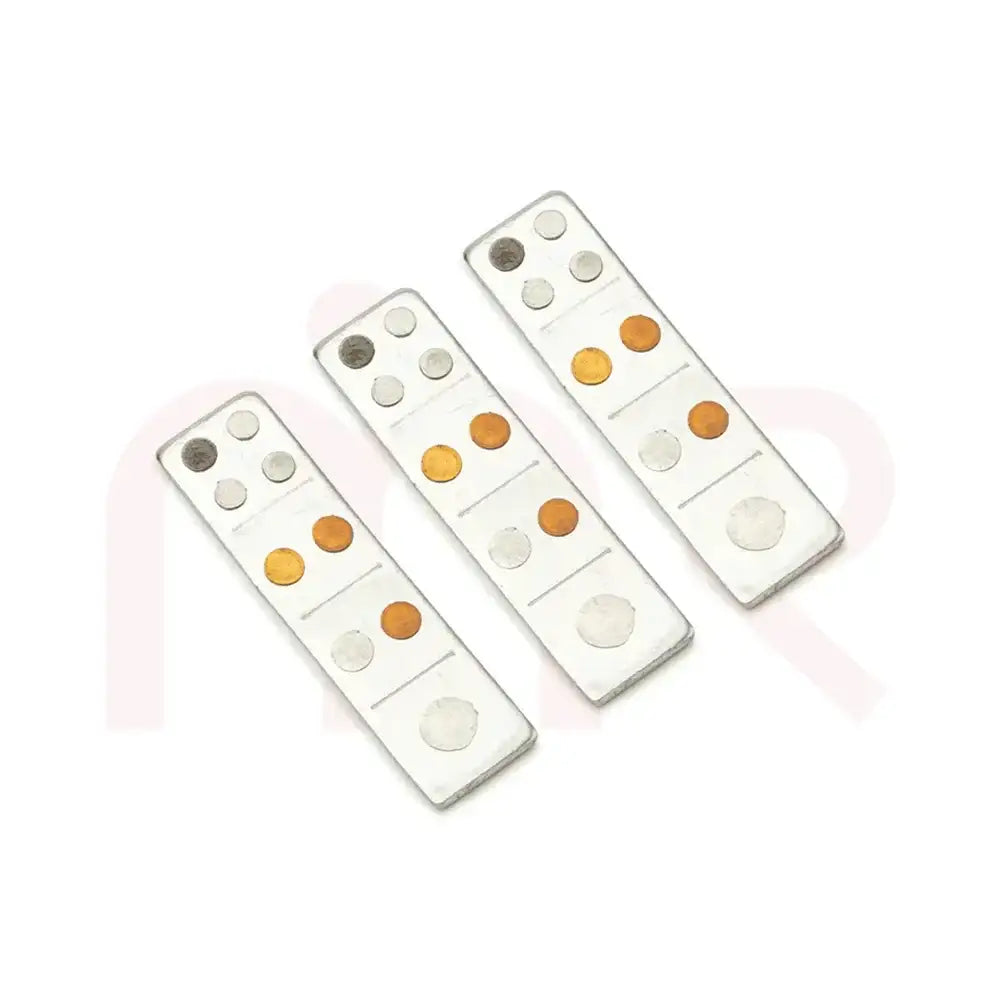 Three metal strips with copper and silver dots for Maha Vastu remedies.