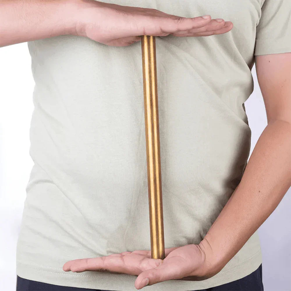 Person holding a brass metal strip, MahaVastu Vastu Shastra remedy tool