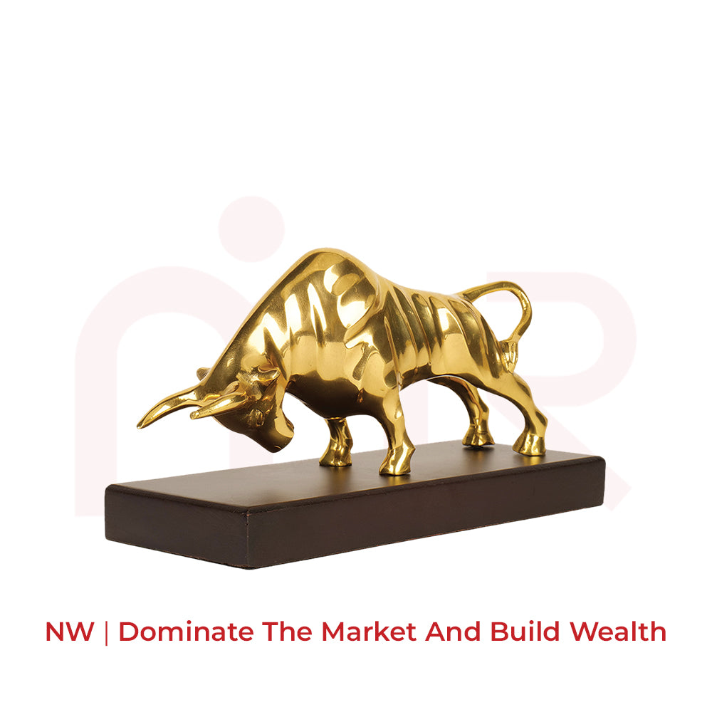 Gold charging bull statue on a dark base for Vastu wealth and prosperity remedies
