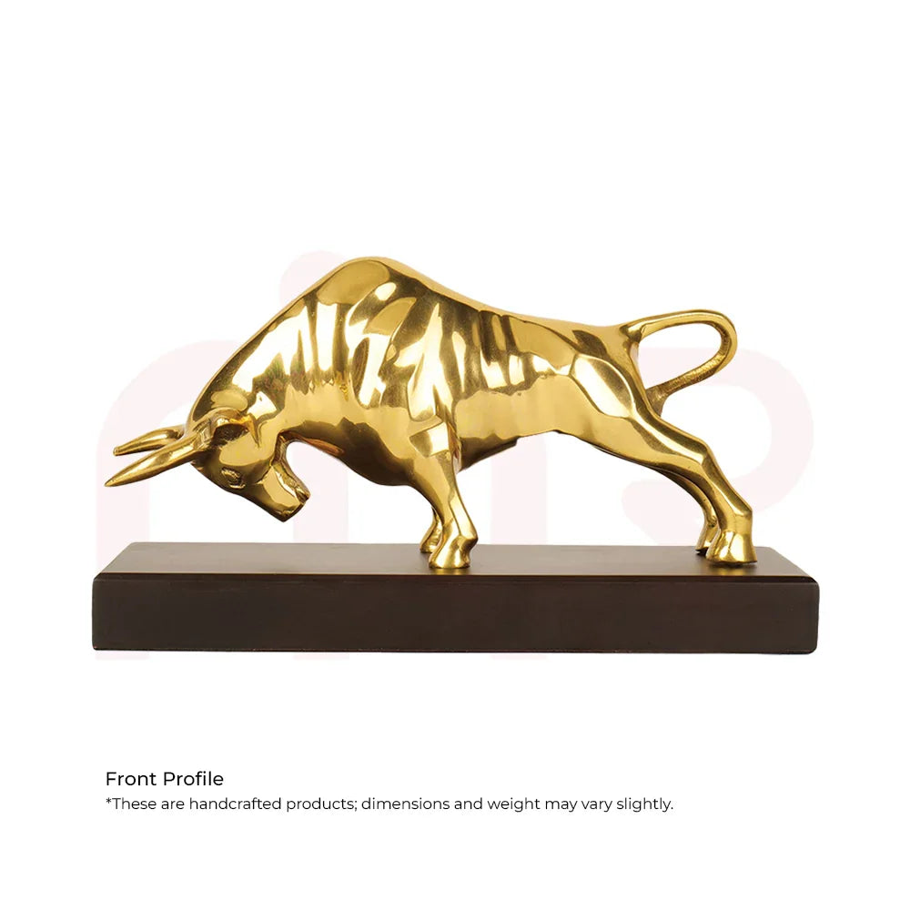 Golden charging bull statue on dark base, Vastu decorative remedy for wealth and prosperity