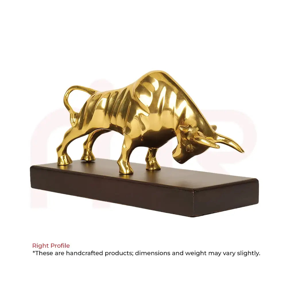 Golden bull statue on a dark wooden base for Vastu prosperity and wealth.