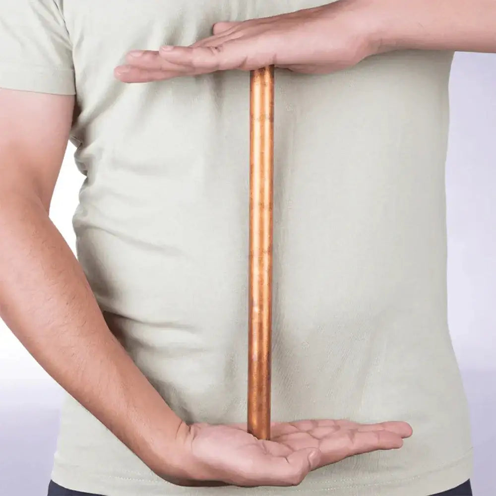 Copper Vastu rod held between hands for energy balancing and home harmony