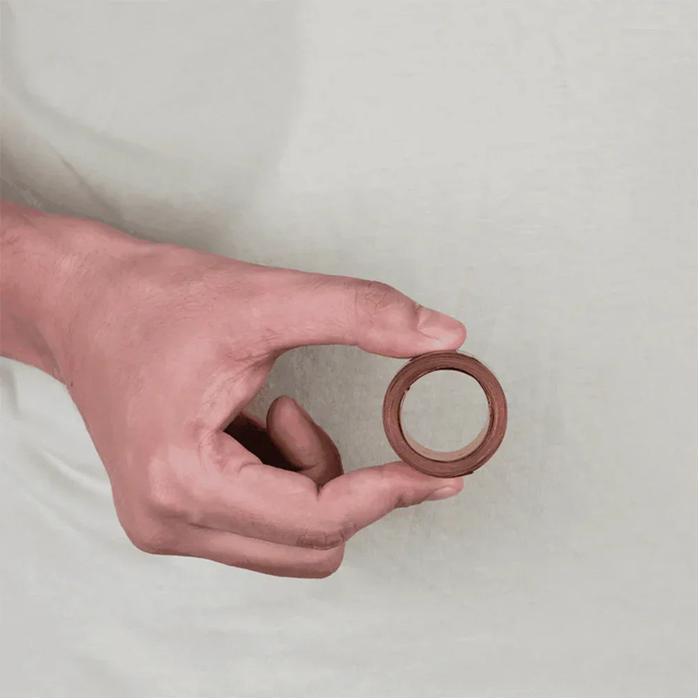 Hand holding a copper ring MahaVastu remedy for Vastu Shastra balance and positivity
