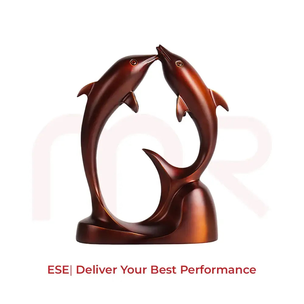 Two bronze dolphins jumping towards each other on a decorative pedestal base.