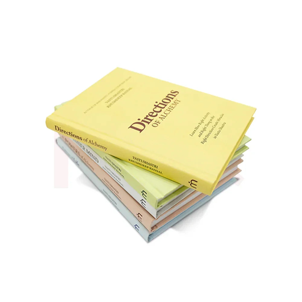 Stack of Vastu Shastra books with 'Directions of Alchemy' on top, isolated on white