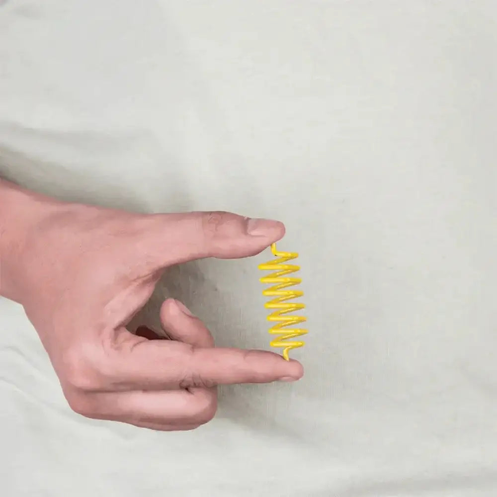 A hand holding a yellow Vastu color tape strip for space balancing remedies.