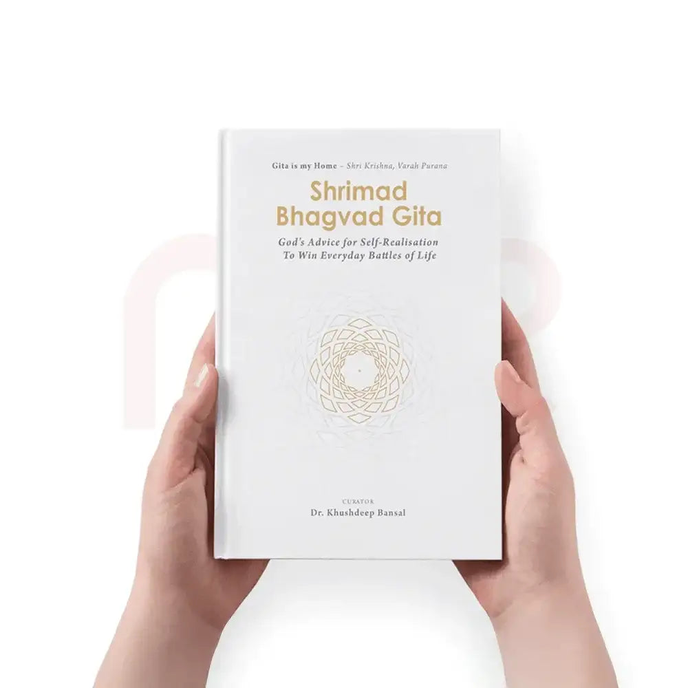 Hands holding a white hardcover book titled Shrimad Bhagvad Gita for spiritual guidance.