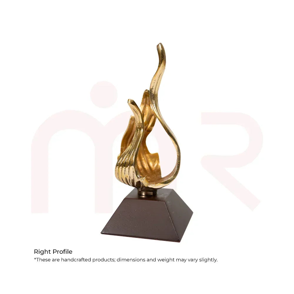 Handcrafted brass flame Vastu remedy sculpture on dark square base for positive energy