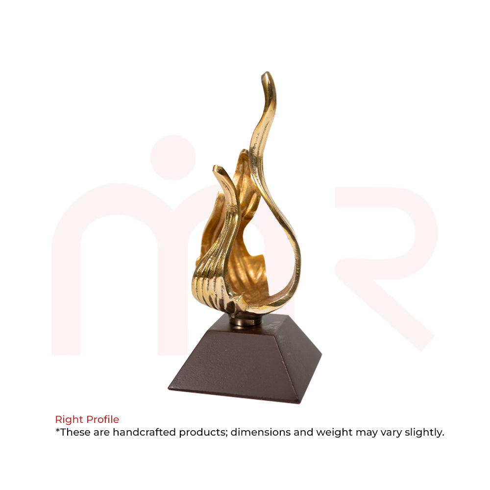 Handcrafted brass flame Vastu remedy sculpture on dark square base for positive energy