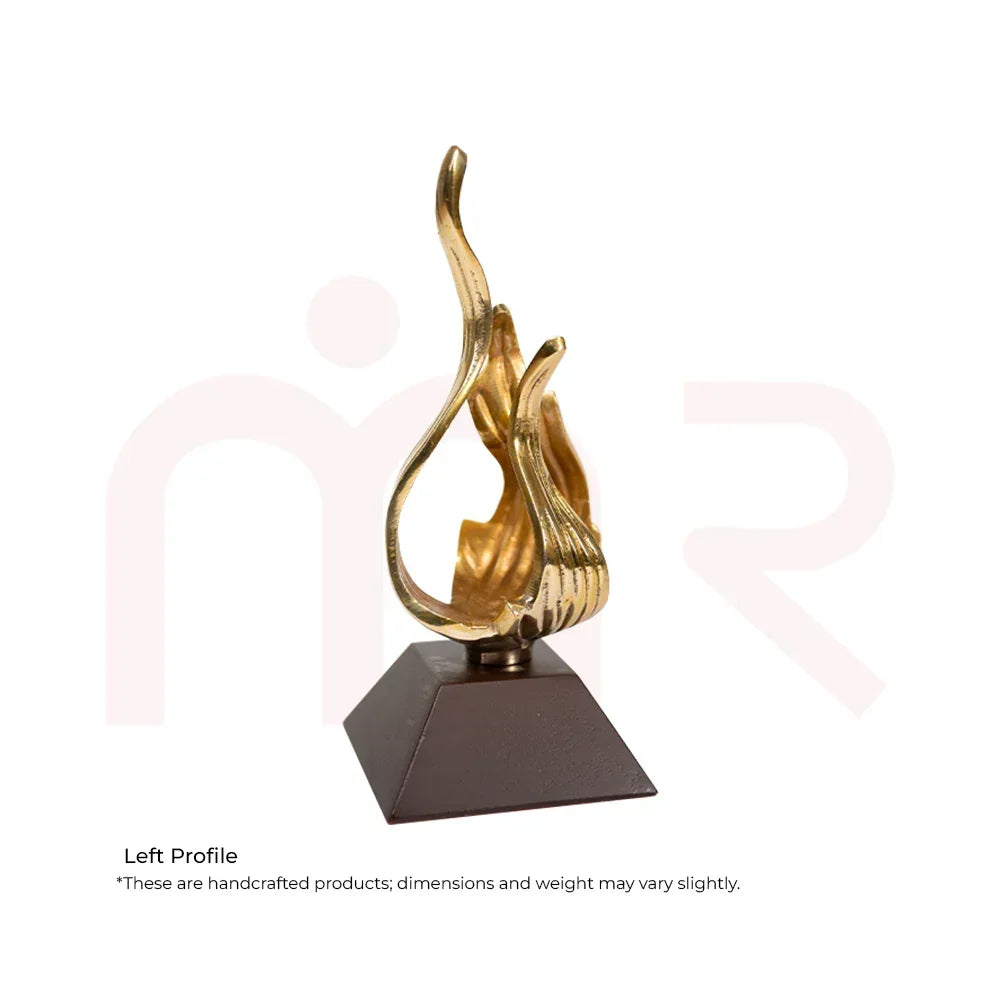 Handcrafted golden flame figurine on a dark base, Vastu decor remedy for balance and positivity