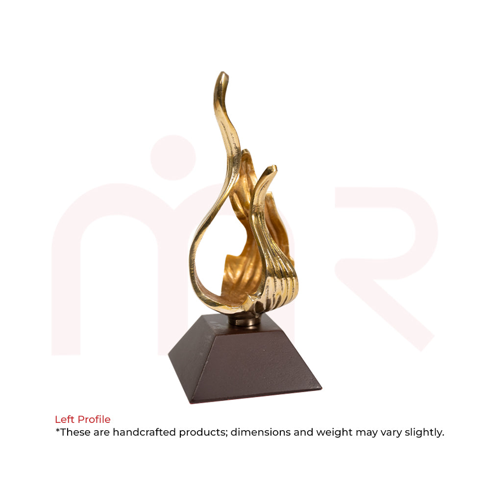 Handcrafted golden flame figurine on a dark base, Vastu decor remedy for balance and positivity