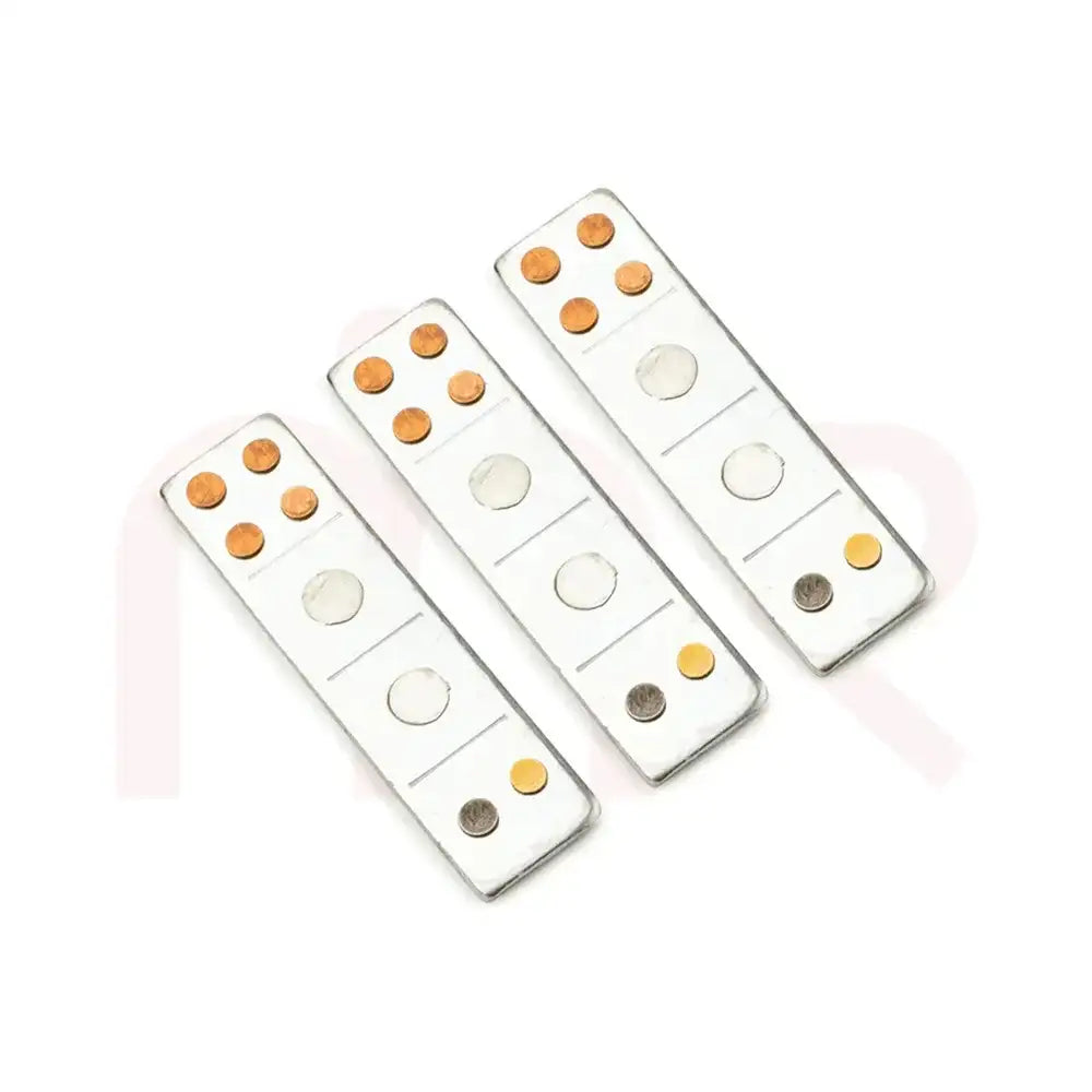 Three silver metal strips with copper and brass studs for Vastu Shastra remedies.