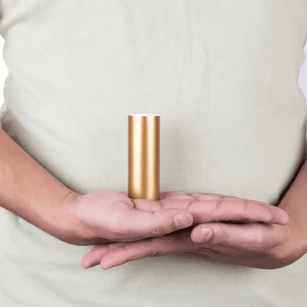 Golden Vastu metal strip held in hands for home energy balance and positivity