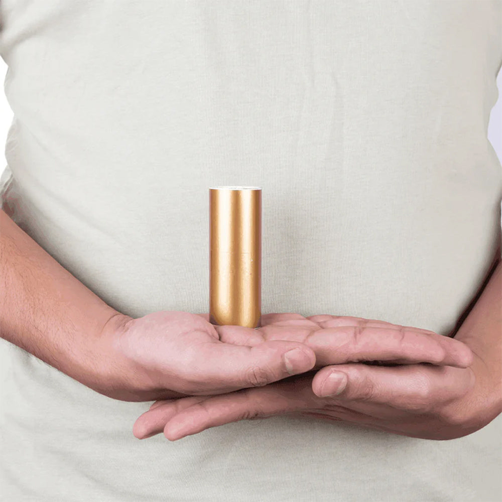 Person holding a gold MahaVastu color tape remedy in both hands
