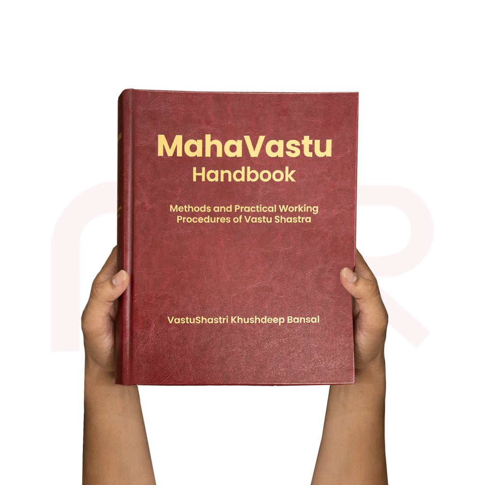 Hardcover Vastu remedies handbook open to home interior photos, with protective box