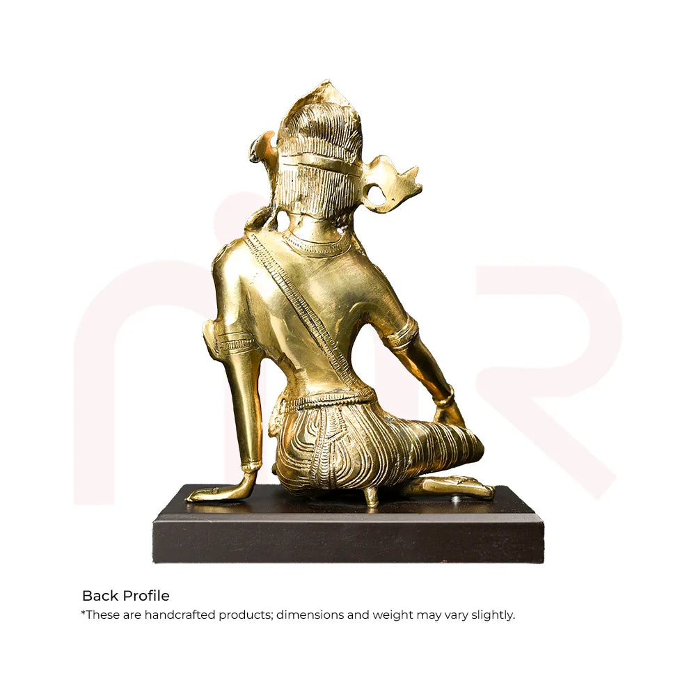 Back view of a handcrafted brass deity idol for Vastu Shastra remedies, on a black base.