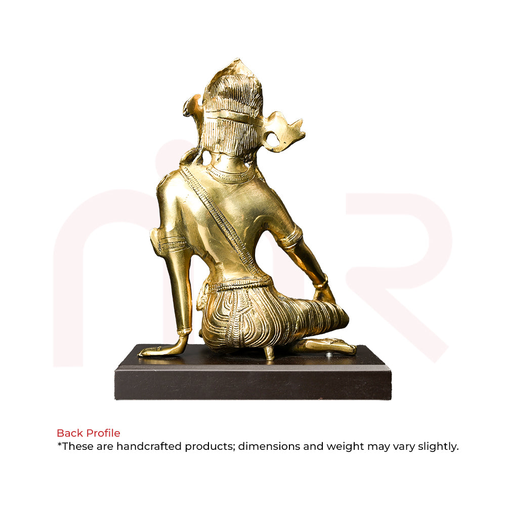 Back view of a handcrafted brass deity idol for Vastu Shastra remedies, on a black base.