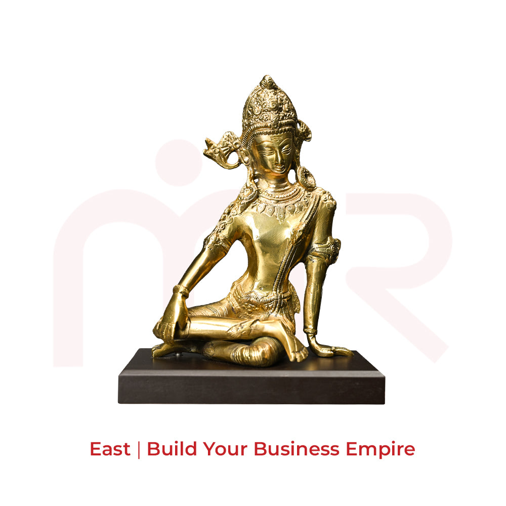 Brass deity idol for Vastu remedies, seated on a dark base, ideal for positivity and prosperity