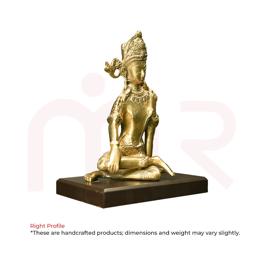 Brass god idol sitting on a dark base, used for Vastu remedies and home decor