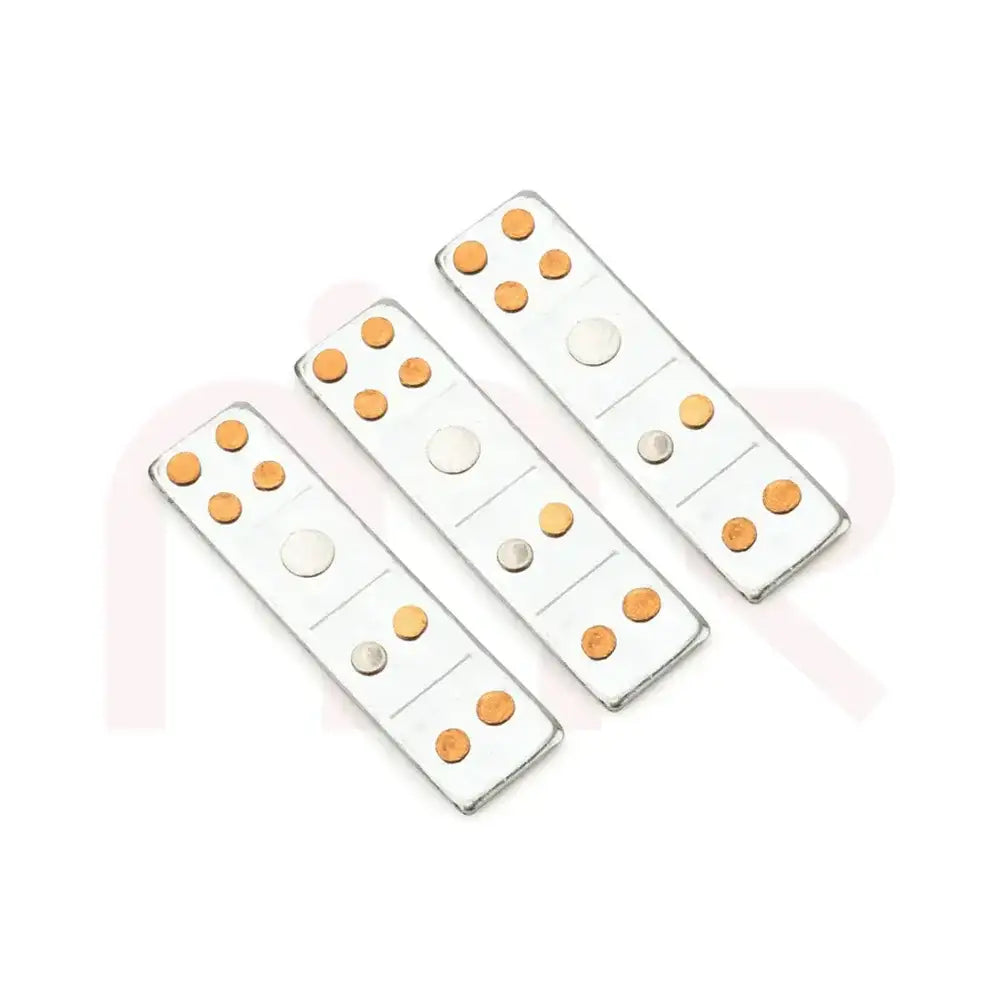Three silver metal strips with copper and brass dots for Vastu Shastra remedies.