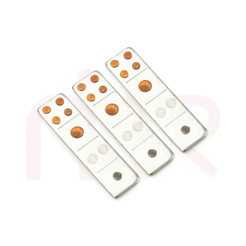 Three silver metal strips with copper and silver dots for Vastu remedy application.