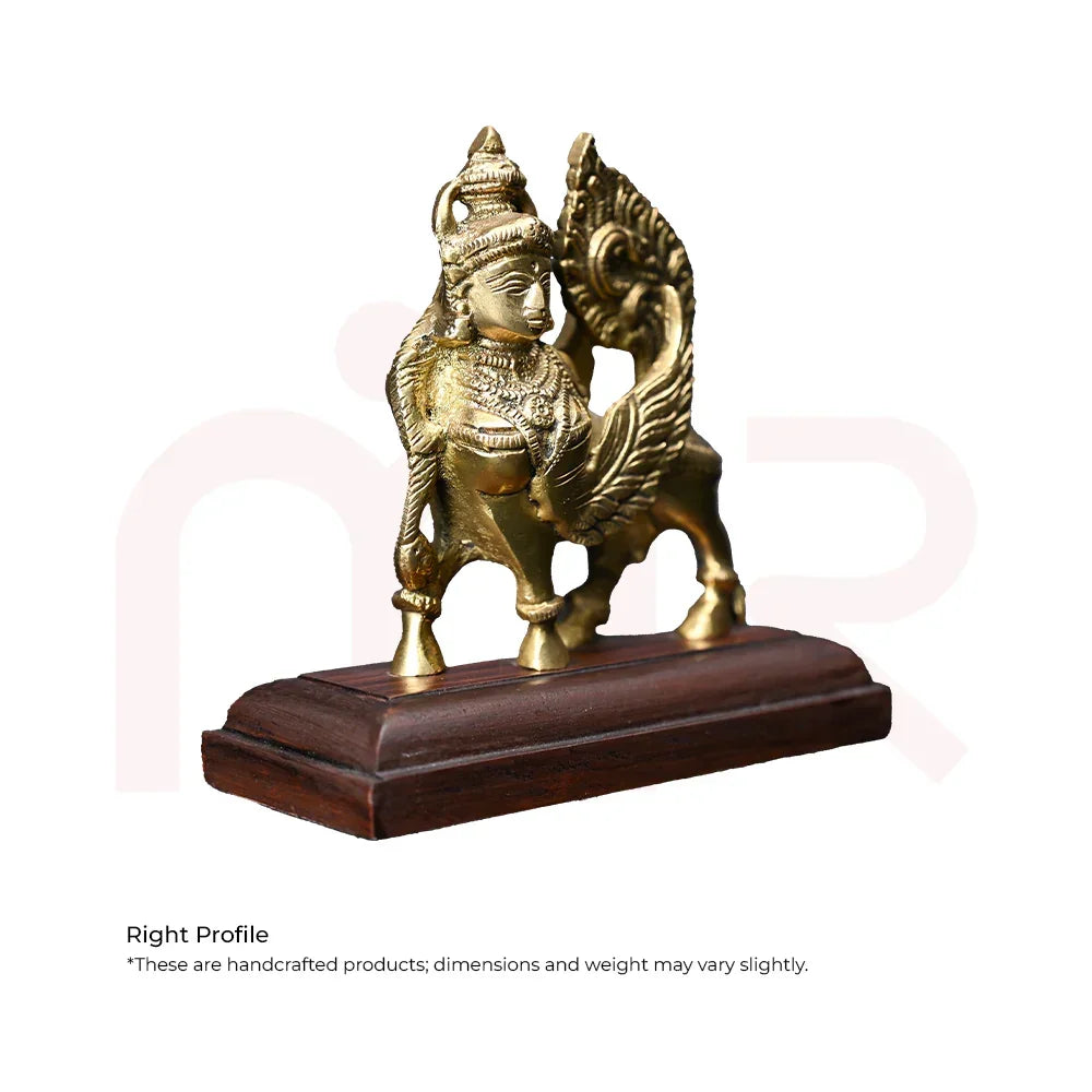 Brass Kamdhenu cow idol with ornate detailing on wooden base, Vastu remedy decor