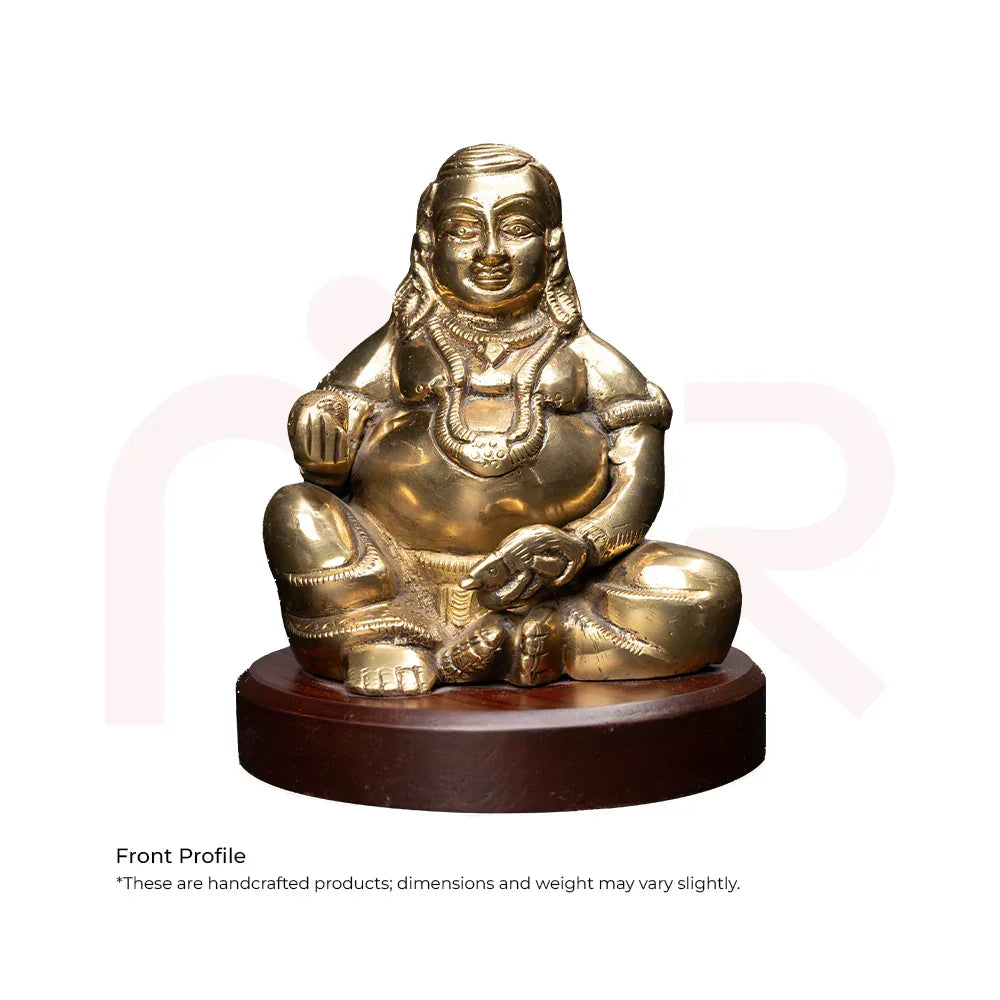 Brass Kuber idol sitting on round wooden base, Vastu Shastra remedy for wealth and prosperity