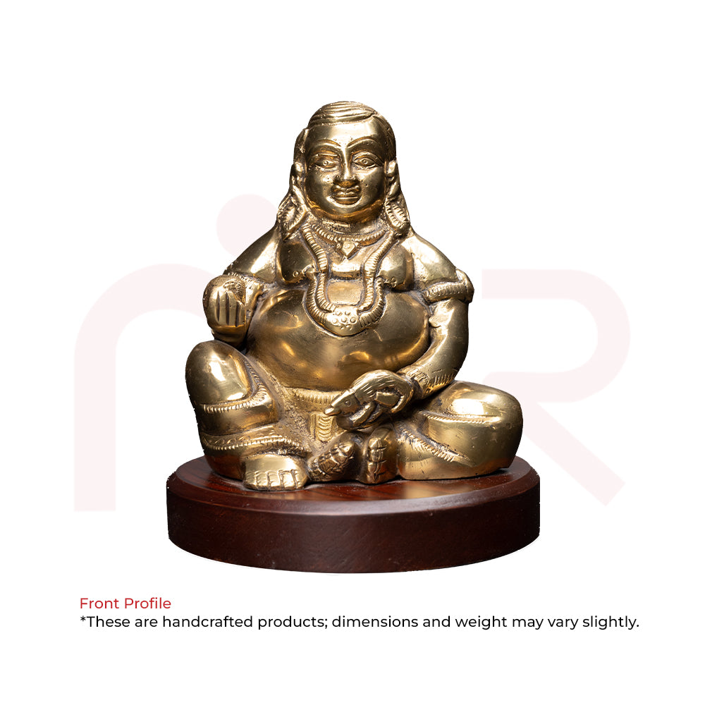 Brass Kuber idol sitting on round wooden base, Vastu Shastra remedy for wealth and prosperity