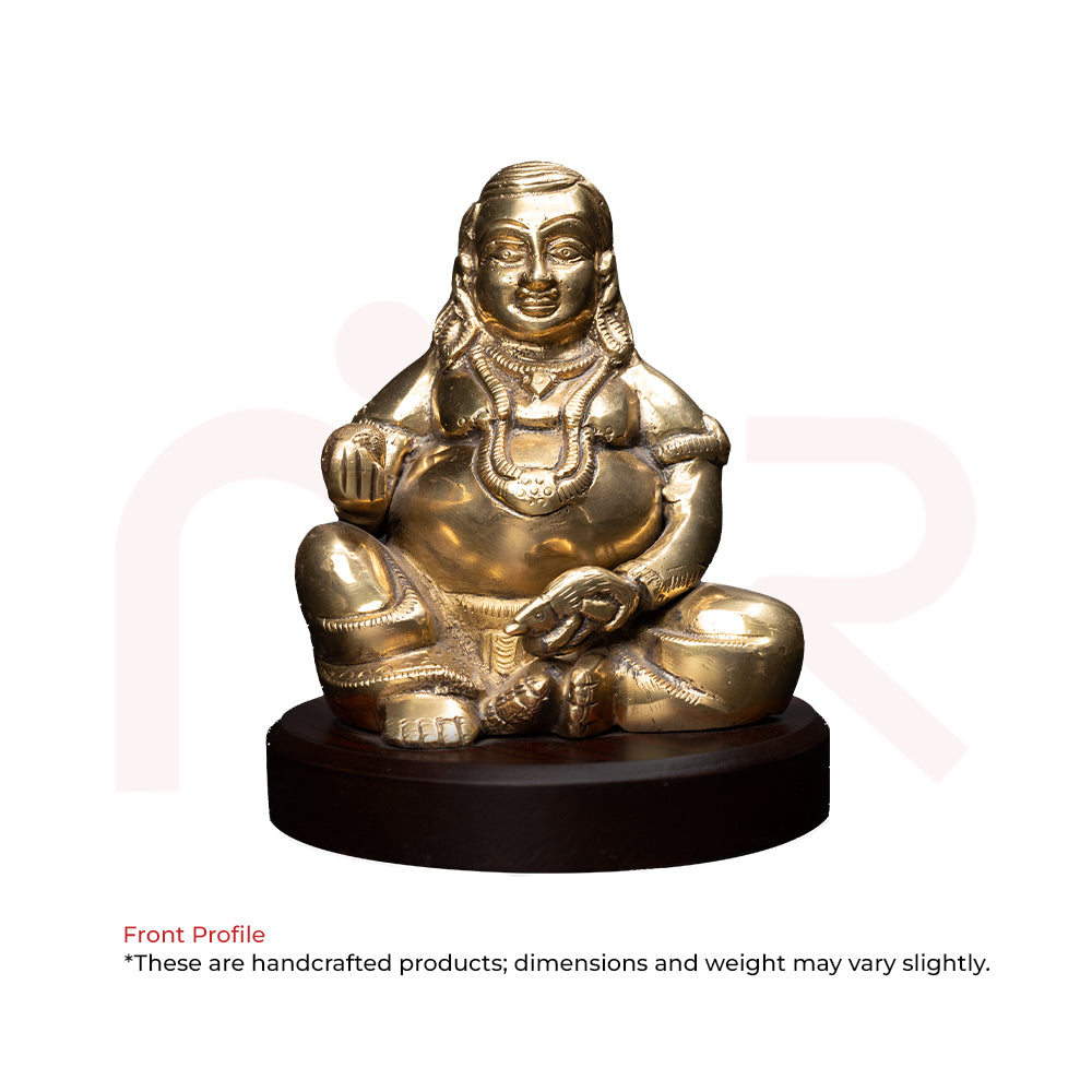 Brass Kuber idol sitting on round wooden base, Vastu Shastra remedy for wealth and prosperity