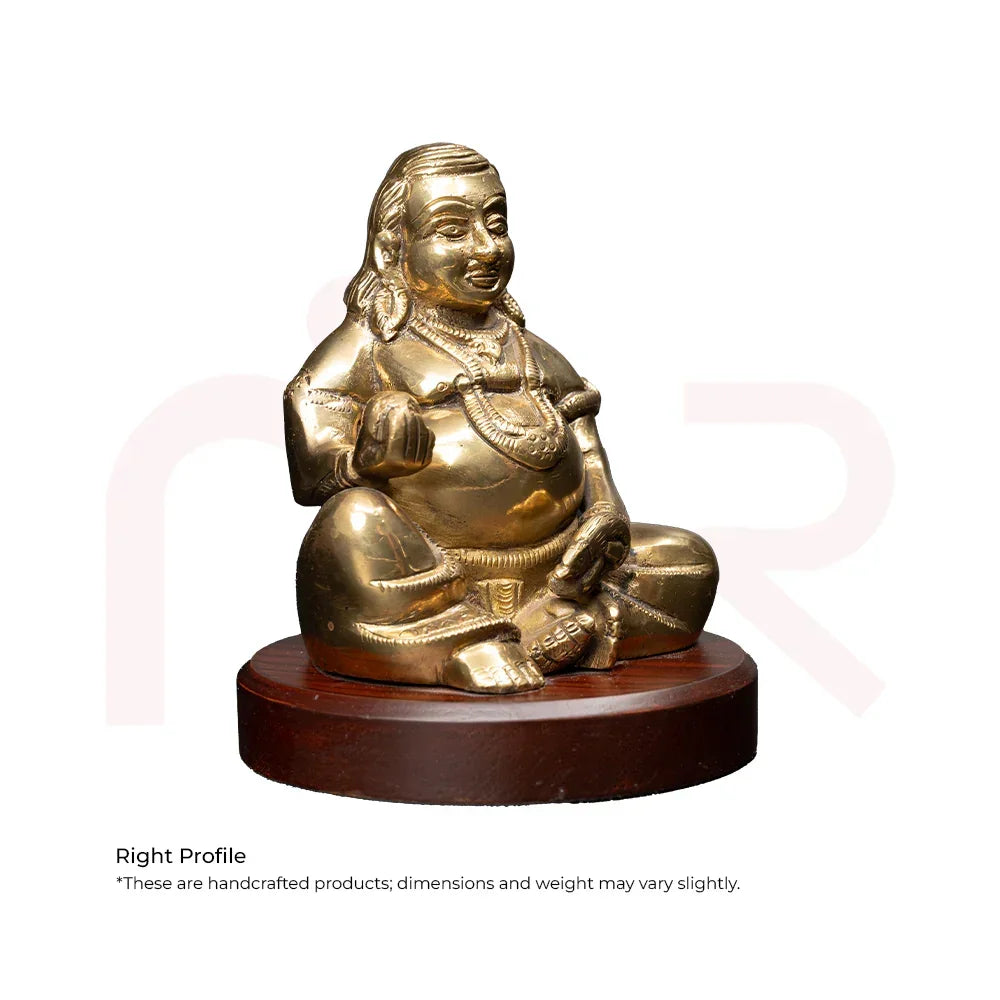 Brass Kuber idol sitting on round wooden base, Vastu remedy for wealth and prosperity
