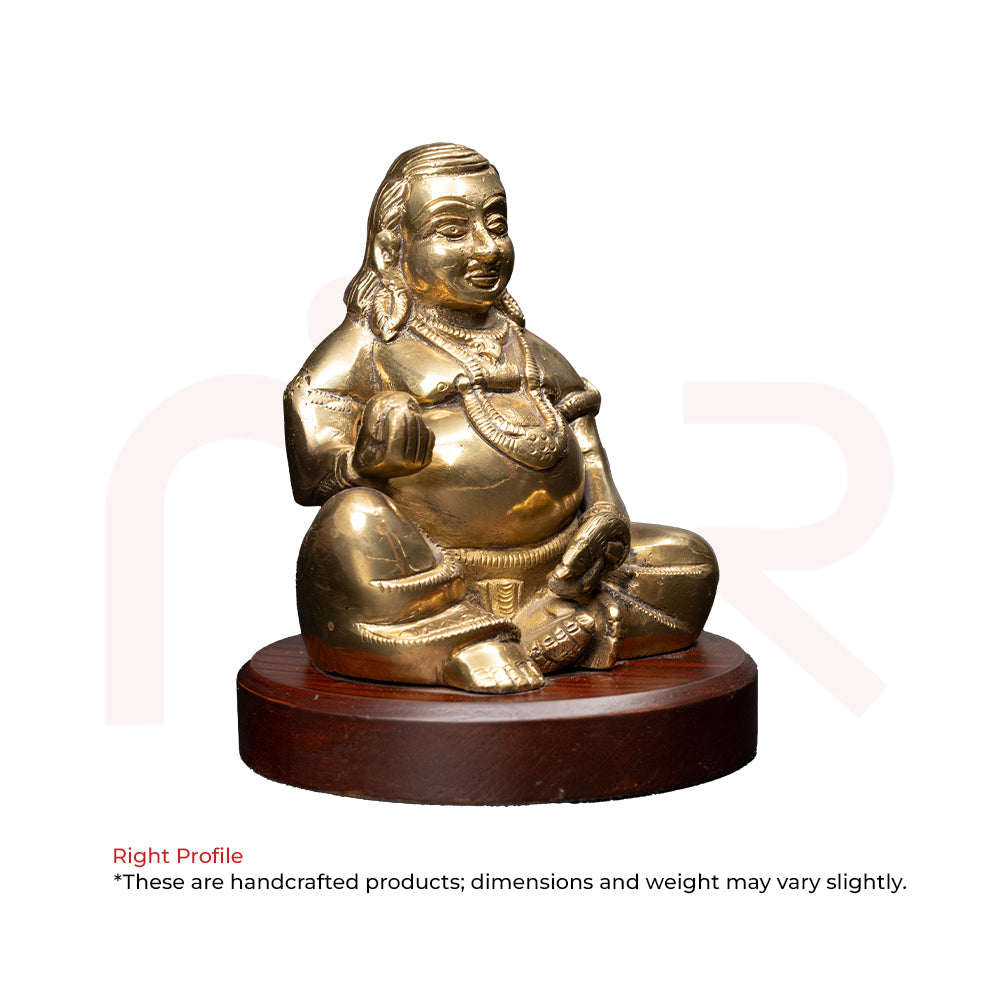 Brass Kuber idol sitting on round wooden base, Vastu remedy for wealth and prosperity
