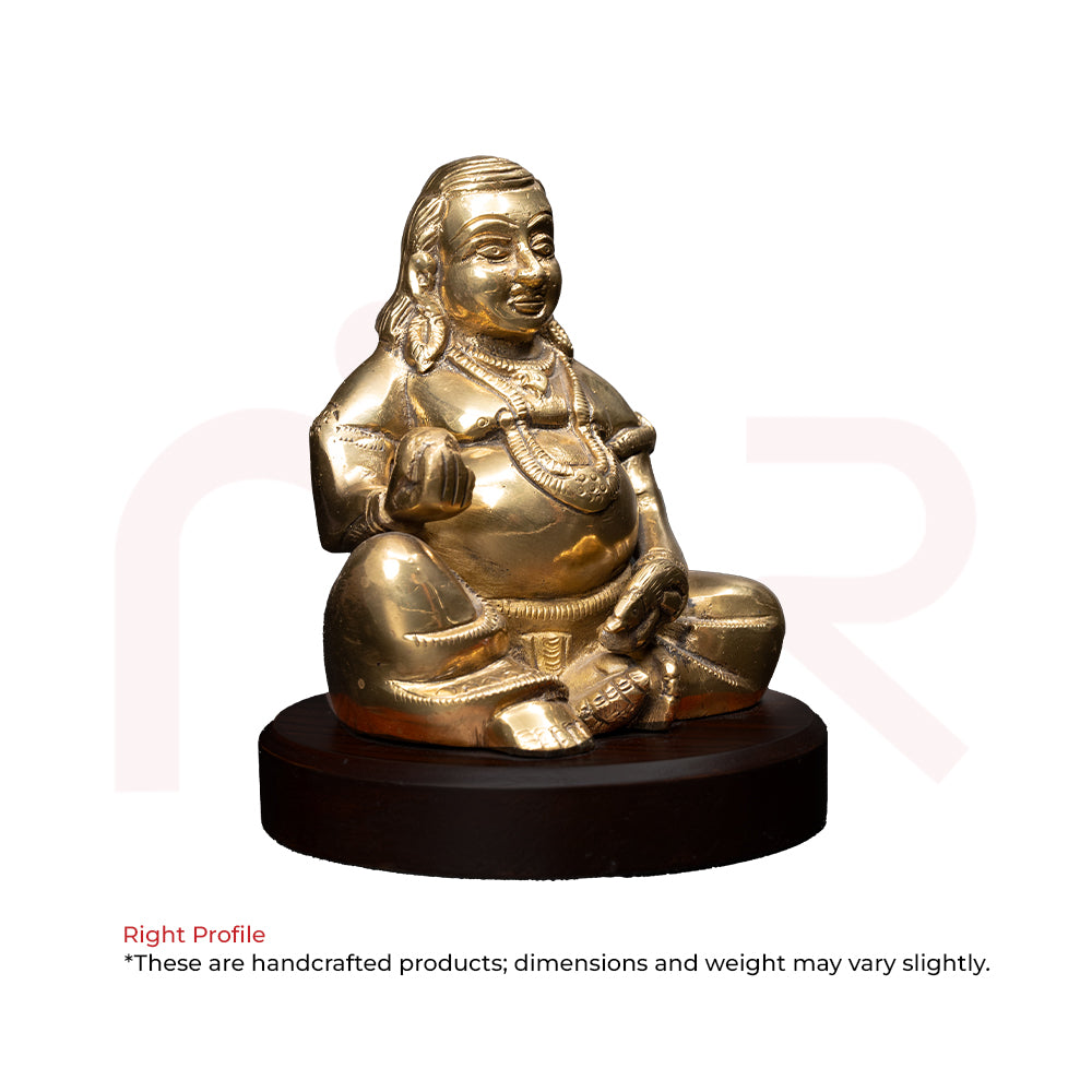 Brass Kuber idol sitting on round wooden base, Vastu remedy for wealth and prosperity