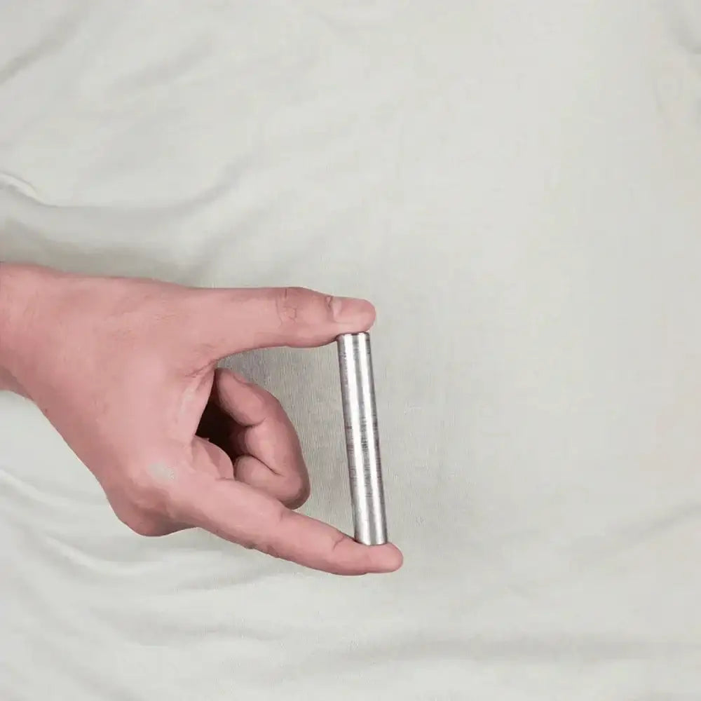 Hand holding a silver Vastu metal strip for home energy balance and positivity