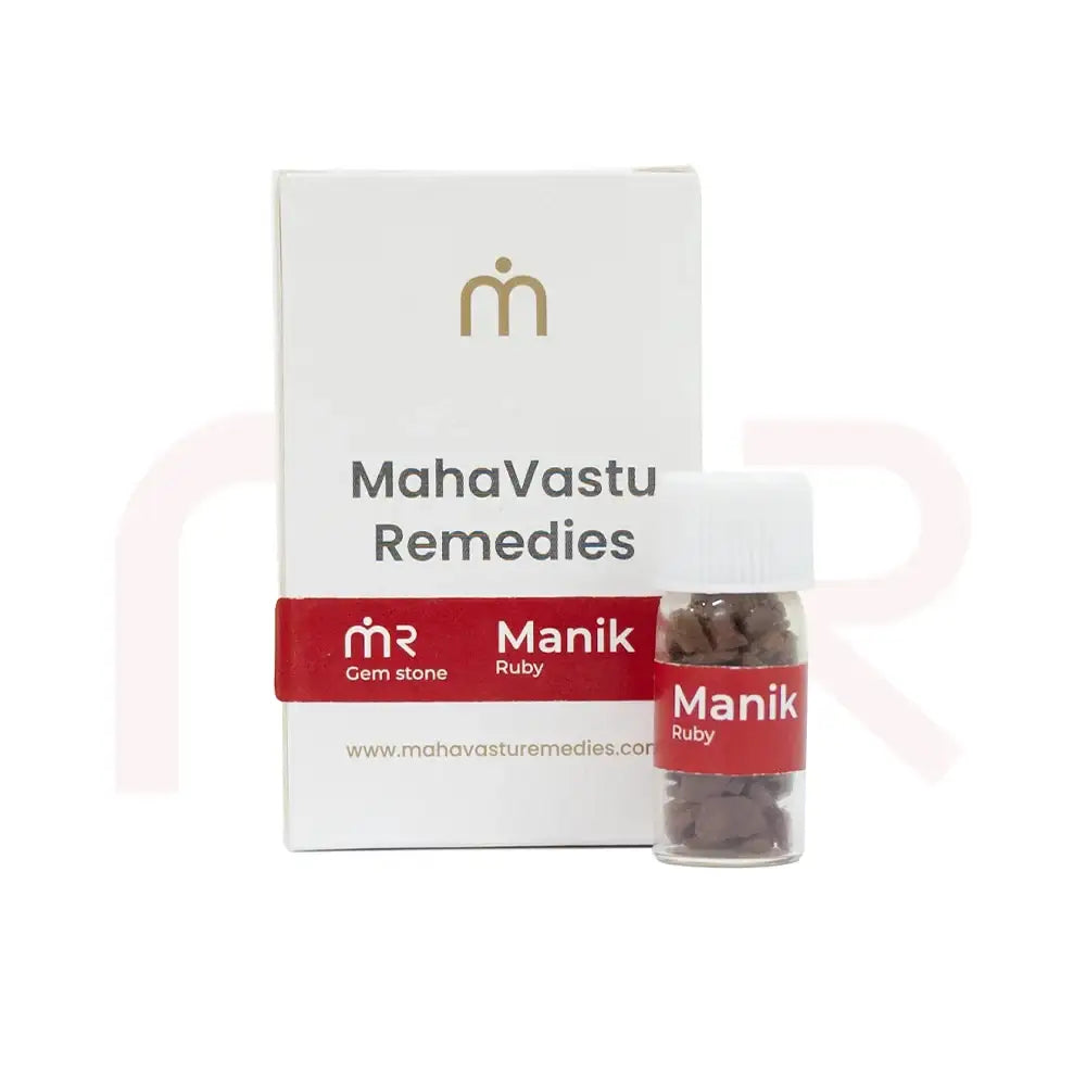Manik Ruby gemstone pieces in a small glass vial with product packaging.