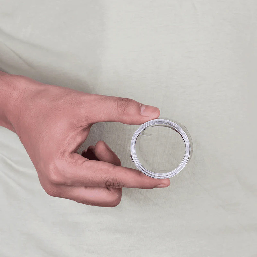 Hand holding MahaVastu iron metal strip remedy for Vastu Shastra balance and positivity