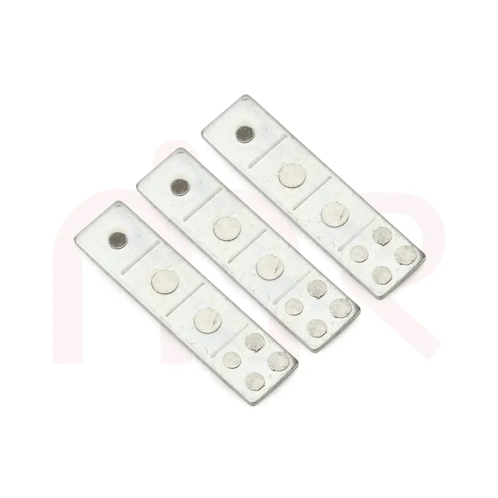Set of three Vastu energy balancing metal strips with circular engravings on white background