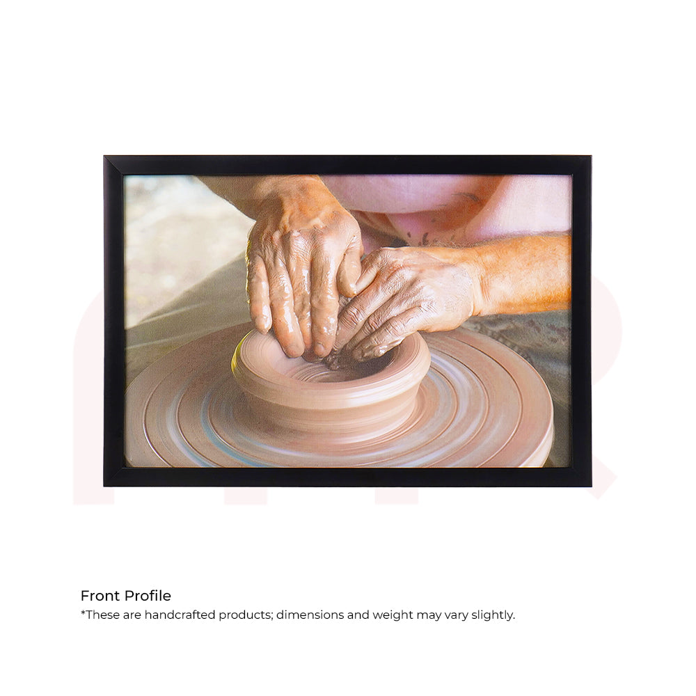 Framed wall art showing hands shaping clay on a pottery wheel, MahaVastu remedy painting
