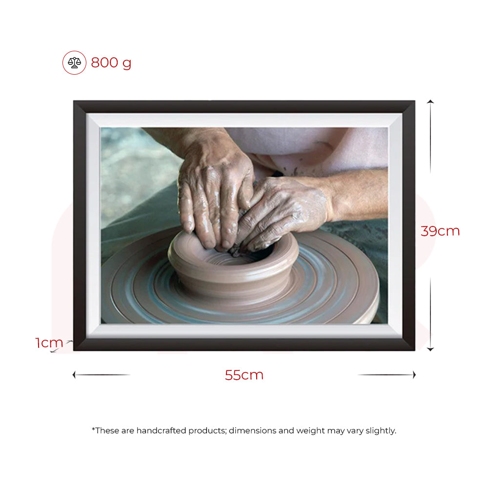 Framed MahaVastu pottery painting, 55x39cm, 800g, showing artisan hands shaping clay.