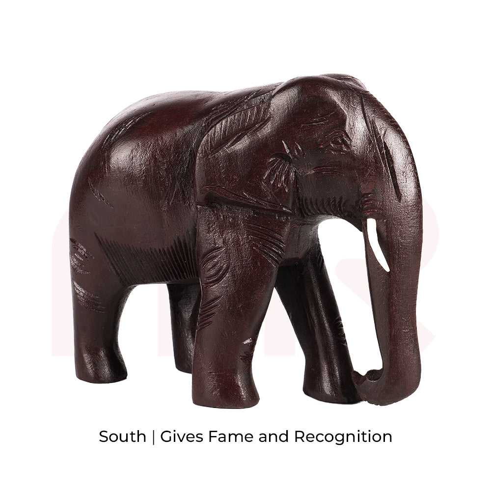 Red wooden elephant figurine for Vastu, symbolizing fame and recognition in the south direction.