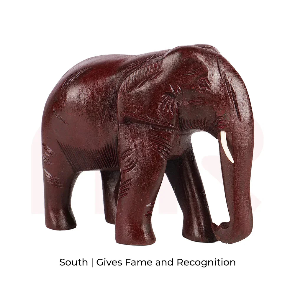 Red wooden elephant figurine for Vastu, symbolizing fame and recognition in the south direction.