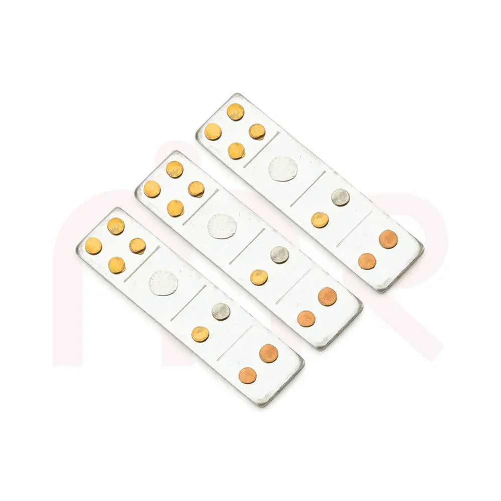 Three Vastu remedy metal strips with copper and brass discs on a white background