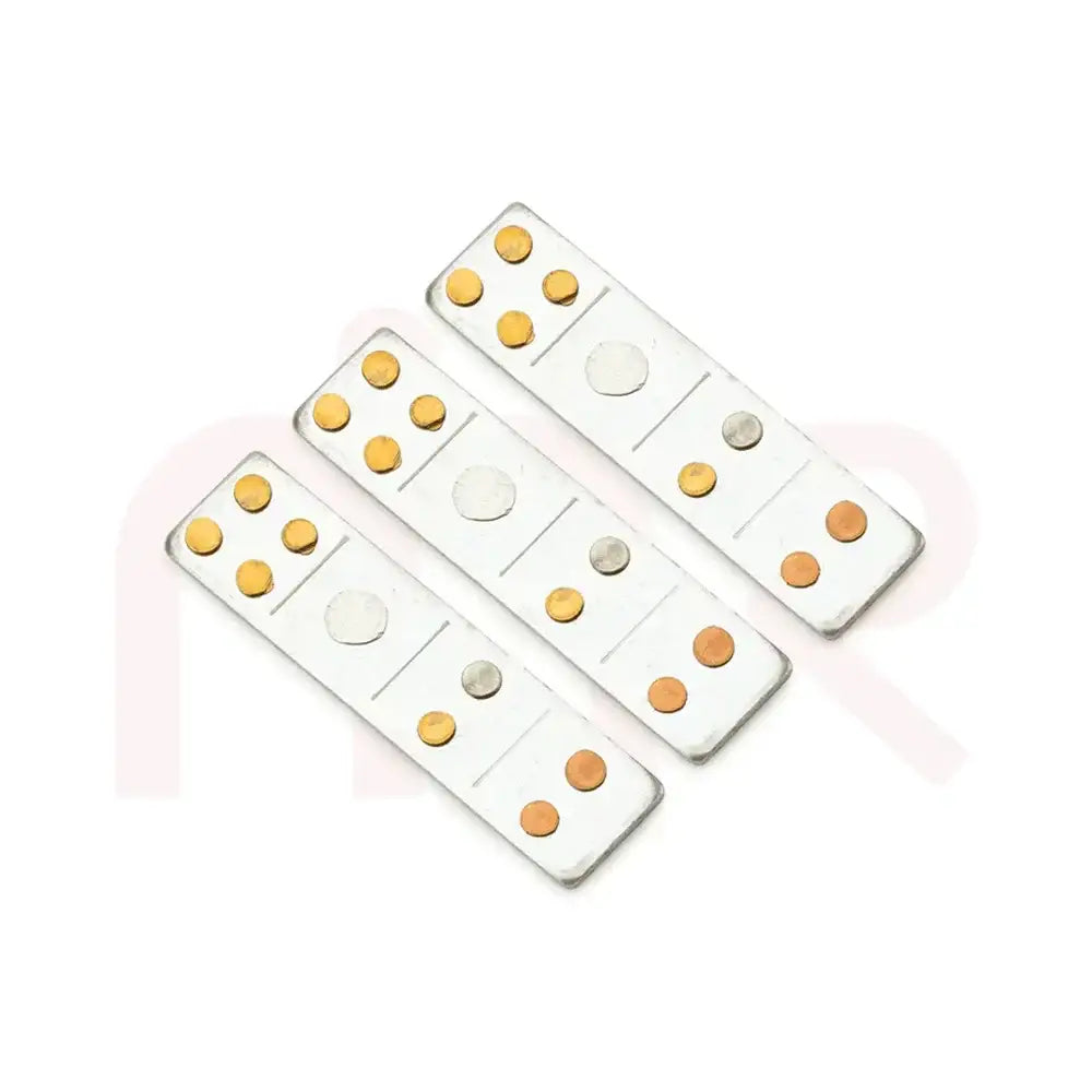 Set of three silver metal strips with brass and copper dots for Vastu remedies.