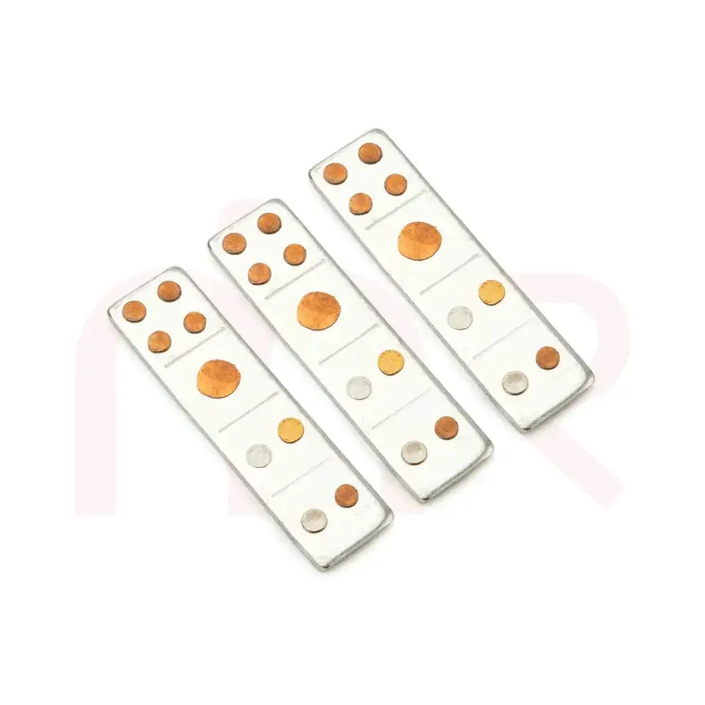 Three silver metal strips with copper and brass dots for Vastu remedies.