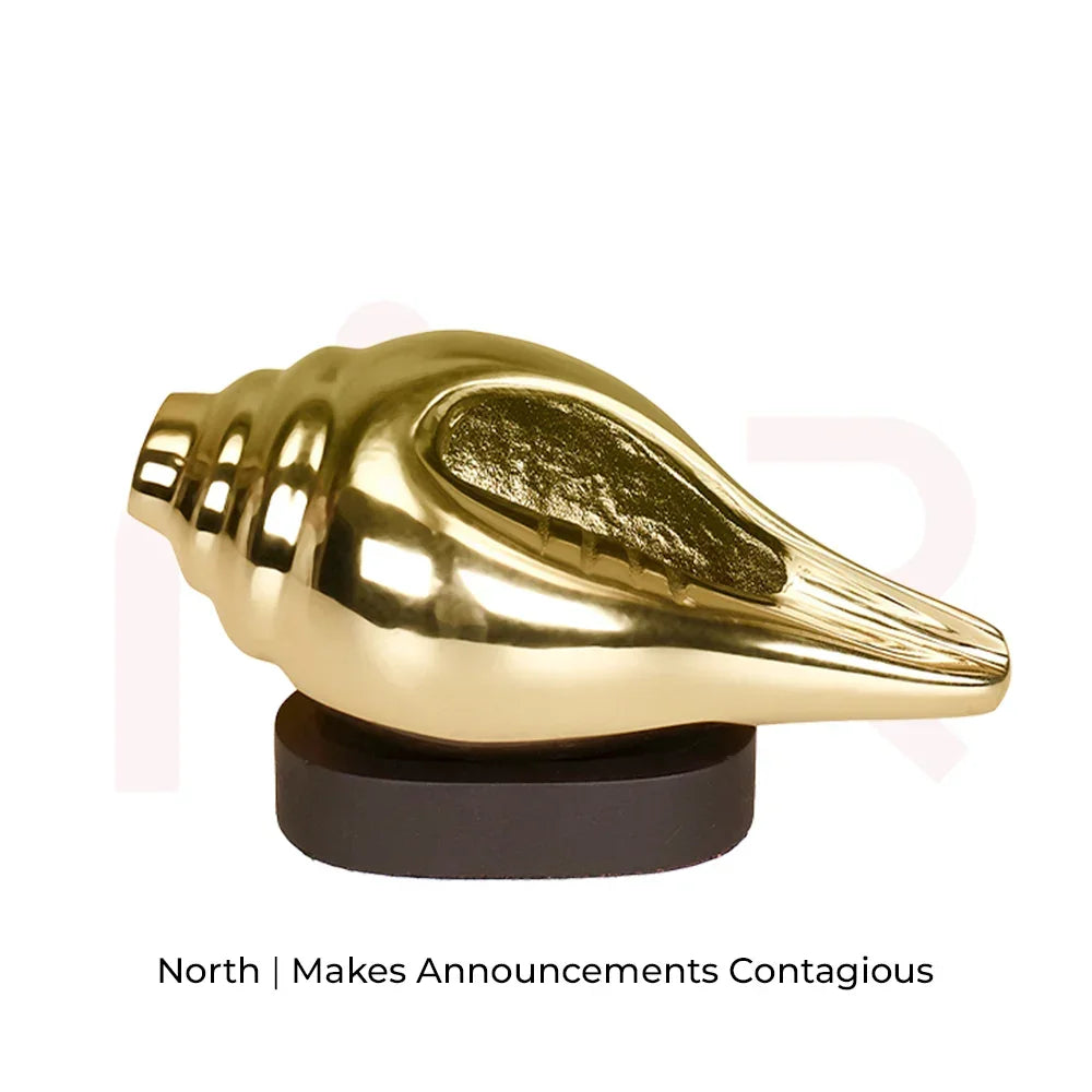 Gold shankh vastu remedy on black base for positivity and energy, isolated on white background